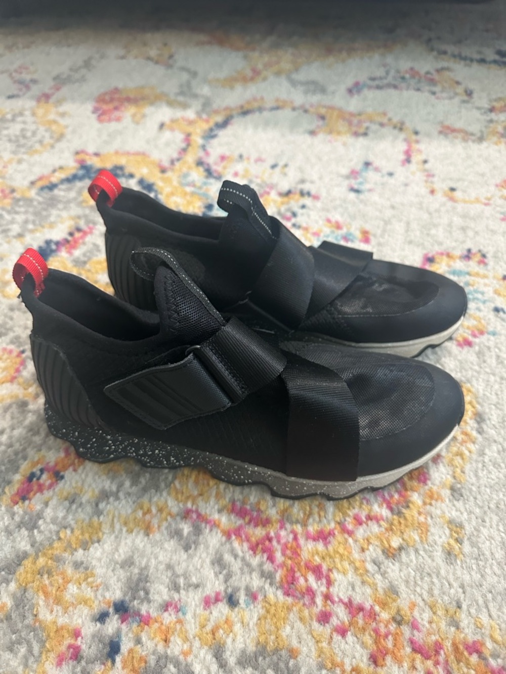 Sorel Kinetic Black Slip-On Sneakers with Red Heel Tabs